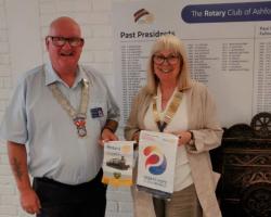 Banners from Minster and Ashford Clubs are swapped between DG Ray and President, Renate